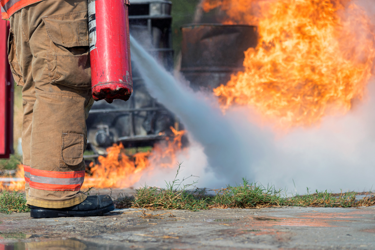 Firefighter using Fire Extinguisher.